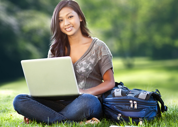 Girl Using Laptop In Field